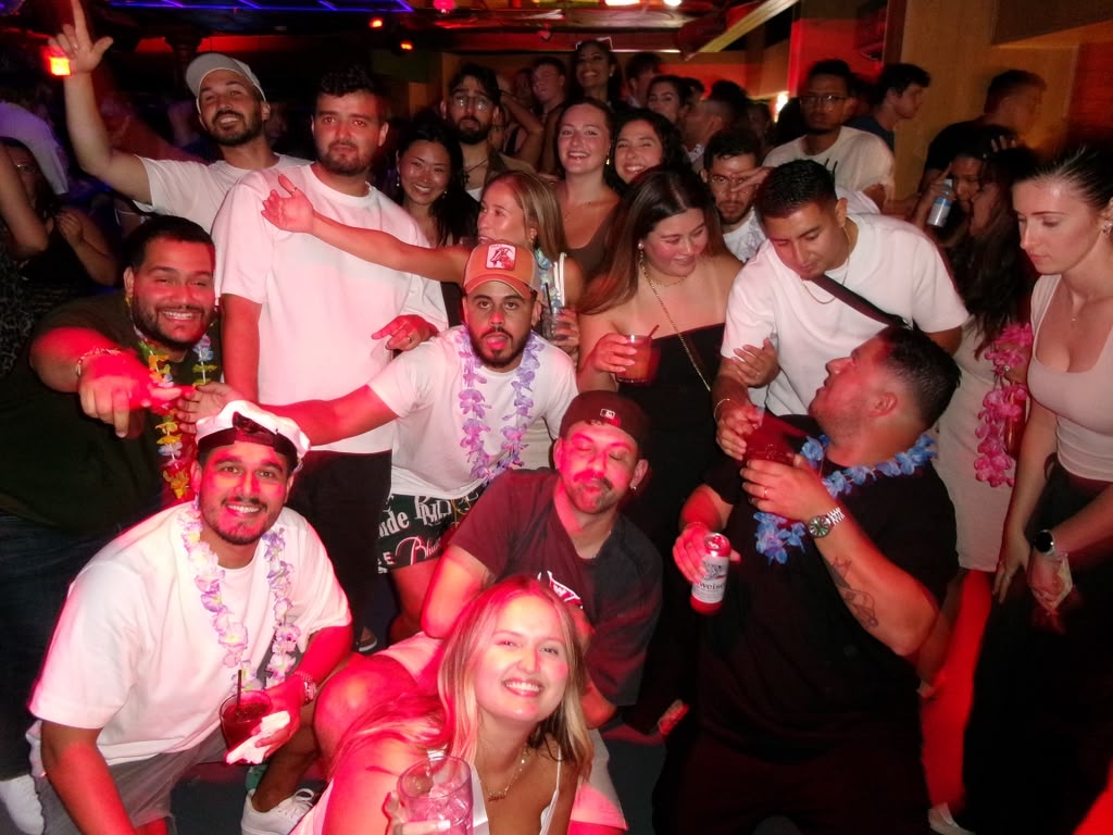 The whole crowd dancing together under red lights