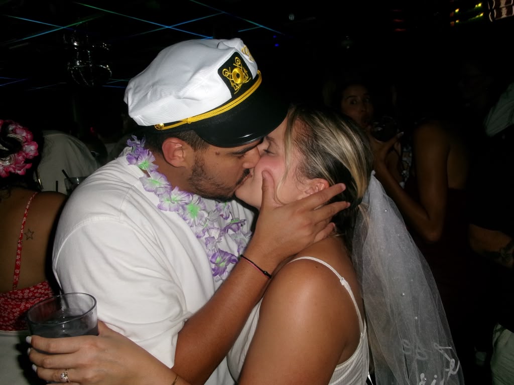 Layza in a veil laughing with a friend on the crowded dance floor