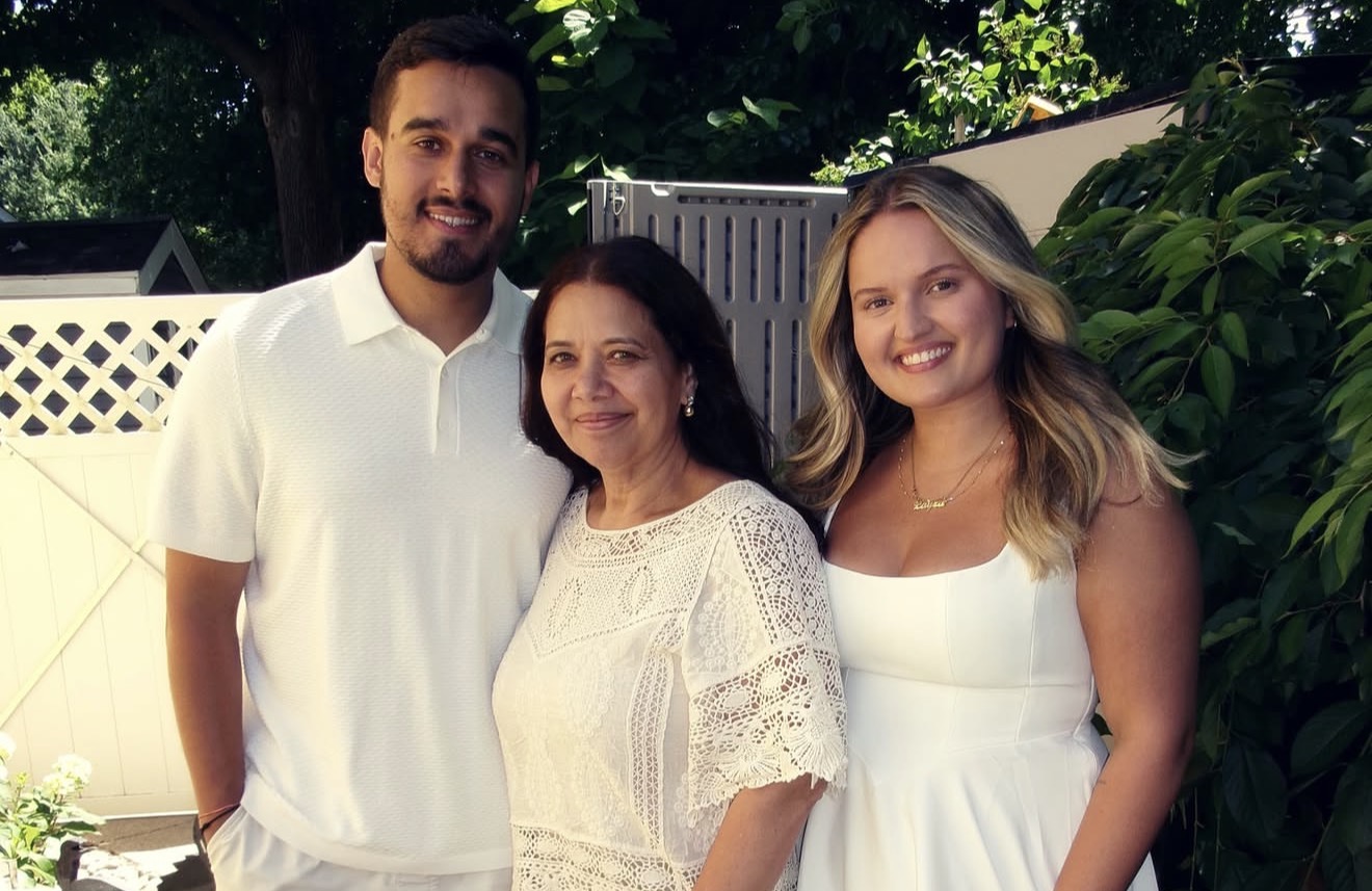 Matheus and Layza in white beside family in the garden