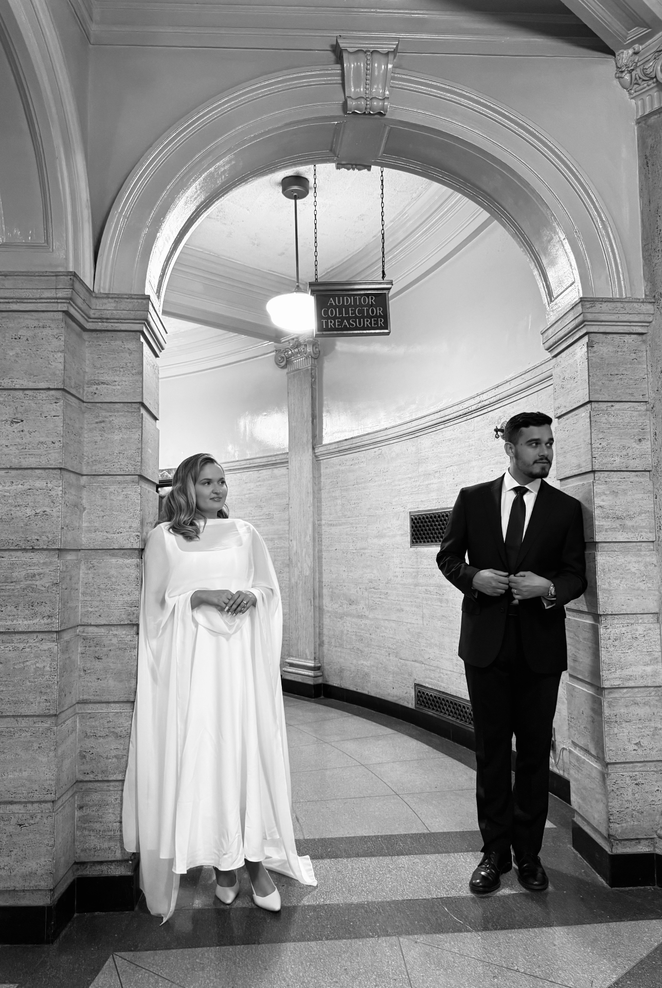 Black and white portrait of the bride and groom in the courthouse rotunda