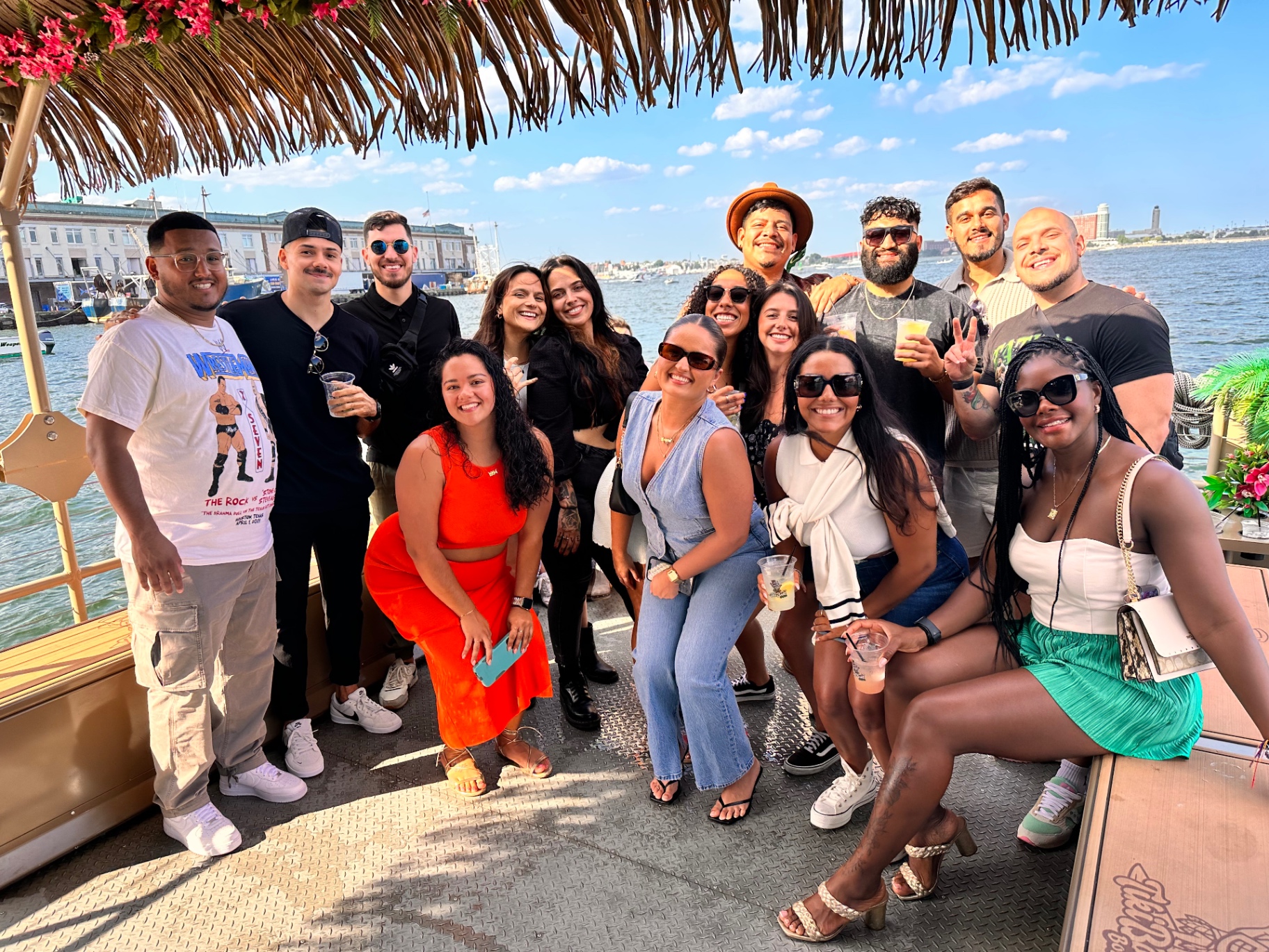 The whole crew gathered under the tiki boat canopy