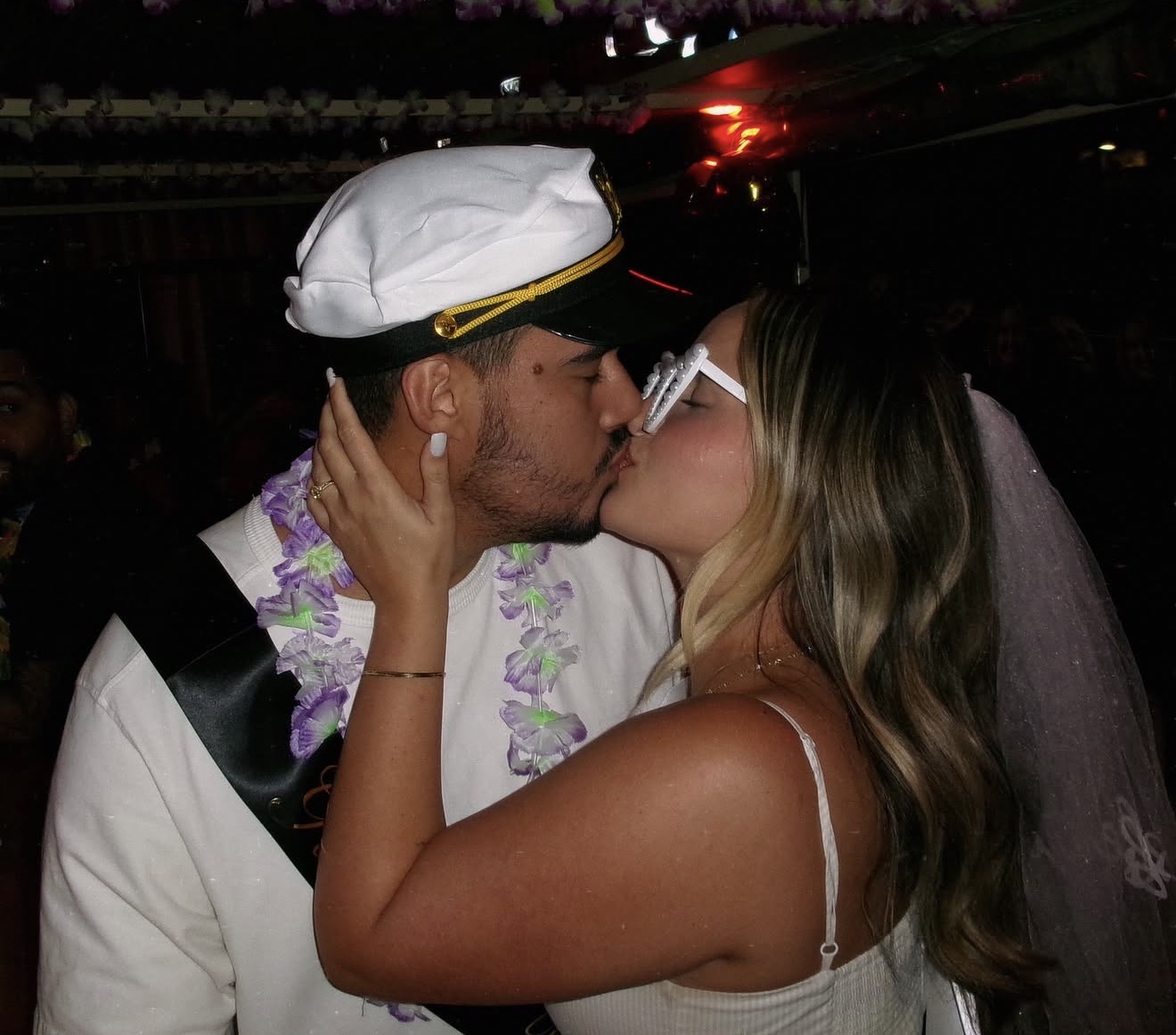 Matheus and Layza kissing at the celebration party